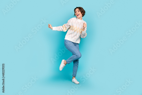 Full body portrait of positive carefree lady chilling dancing free time clubbing isolated on blue color background