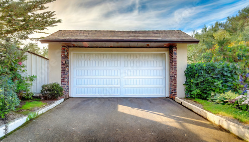 white garage door with a driveway in front © Ashley