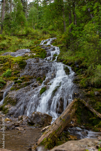 Wide waterfall buried in moss