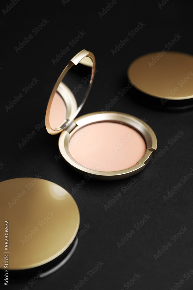 Open face powder with mirror on black background Open face powder with mirror on black background