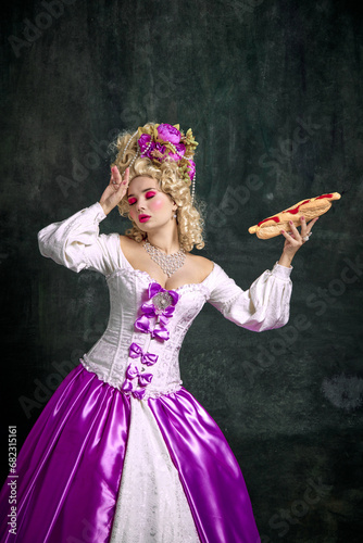 Vászonkép Beautiful woman with bright make up will swoon for delicious smell of huge American hot dog with souses against vintage background