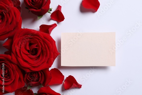 Fototapeta Naklejka Na Ścianę i Meble -  Blank card, beautiful red roses and petals on white background, flat lay. Space for text