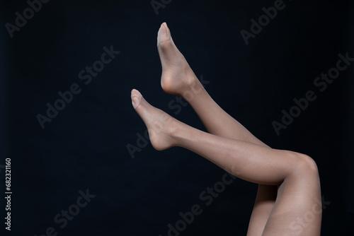 Beautiful women's legs on a black background