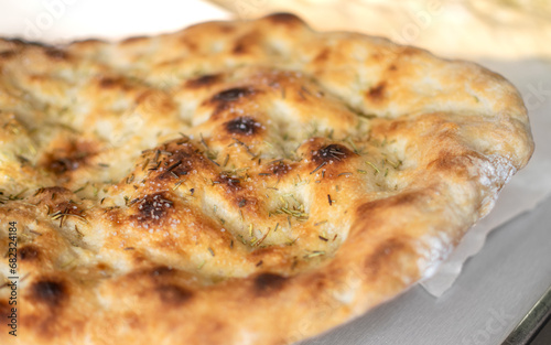 Typical Italian Focaccia Bread dough with oil and rosemary baked
