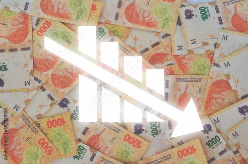 graph with downward arrows with Argentine currency bills in the background showing currency devaluation
