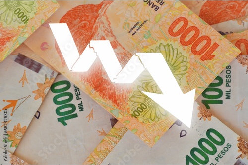 graph with downward arrows with Argentine currency bills in the background showing currency devaluation