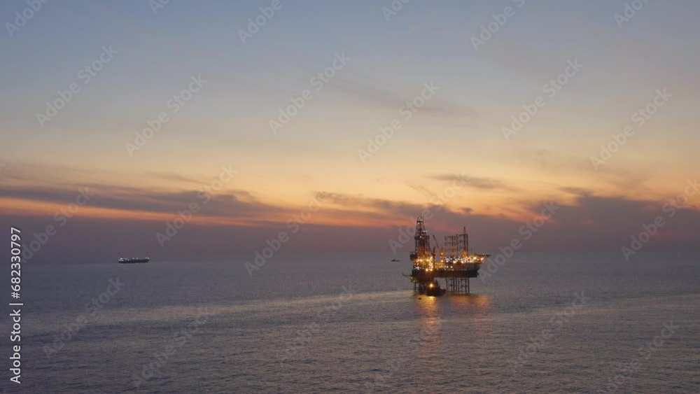 Aerial view of offshore jack up drilling rig during early night time - oil and gas industry
Aerial view of offshore jack up drilling rig during early night time - oil and gas industry
