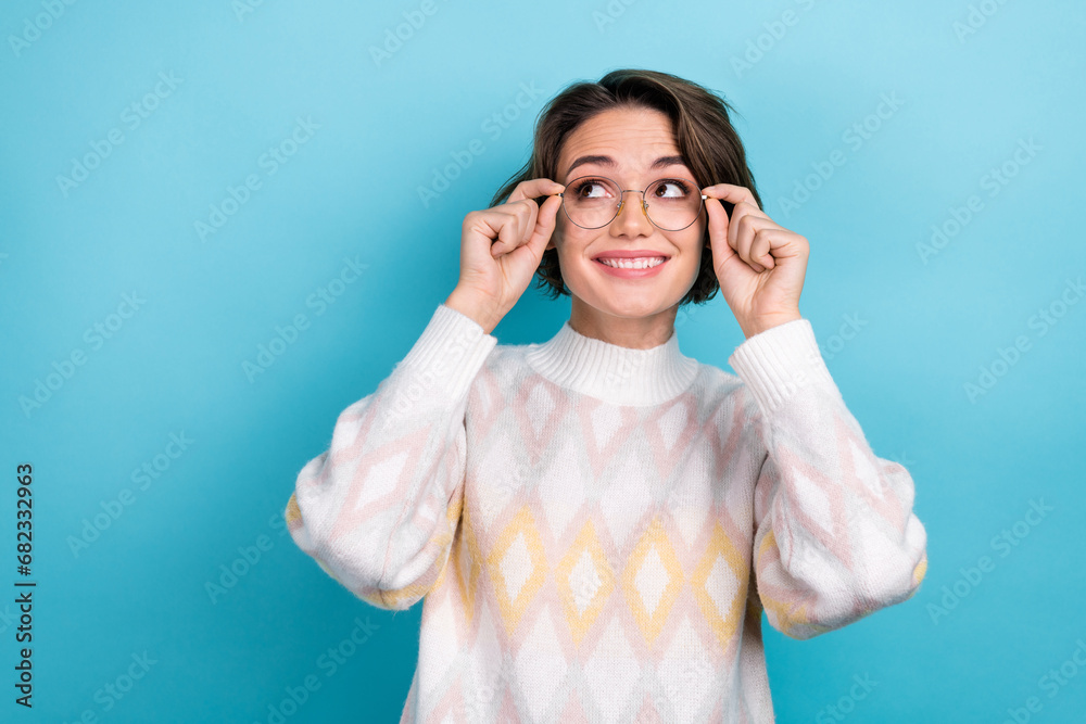 Photo portrait of attractive young woman touch specs look empty space dressed stylish white clothes isolated on blue color background Photo portrait of attractive young woman touch specs look empty space dressed stylish white clothes isolated on blue color background