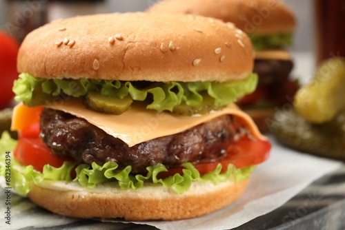 Tasty hamburger with patty on board, closeup