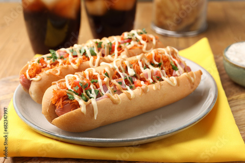 Photography Delicious hot dogs with bacon, carrot and parsley on table, closeup