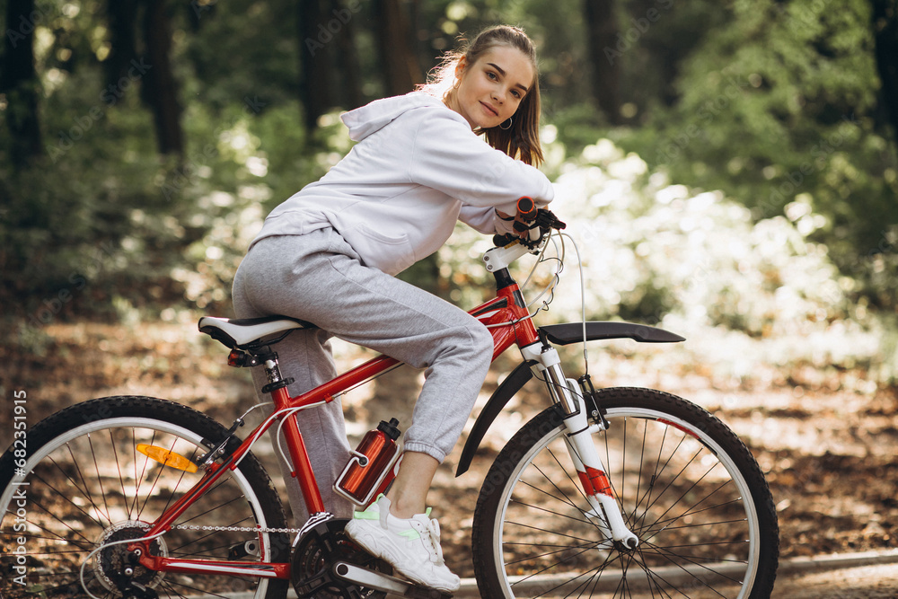 Young sporty woman riding bicycle in the park Young sporty woman riding bicycle in the park