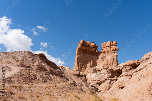 Desert landscape showing eroded rock formations and hoodoos in Utah on a bright sunny day