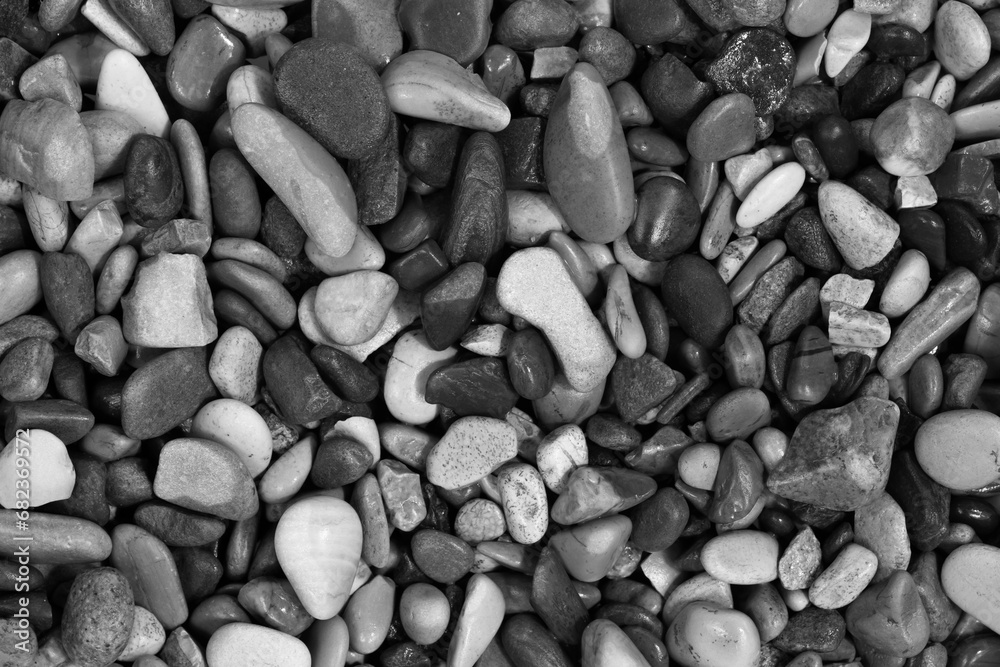 Black sea pebbles background texture. dark aquarium soil. beach pebbles