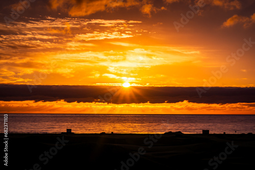 Sunrise over the Atlantic Ocean. Shot from the Dunes of Maspalomas Gran Canaria photo