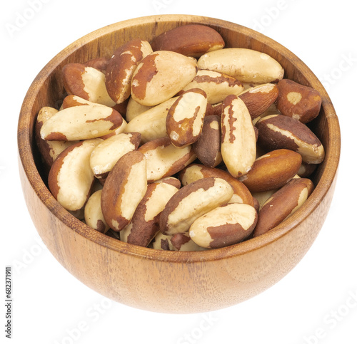 Peeled brazil nut in wooden cup isolated on white background