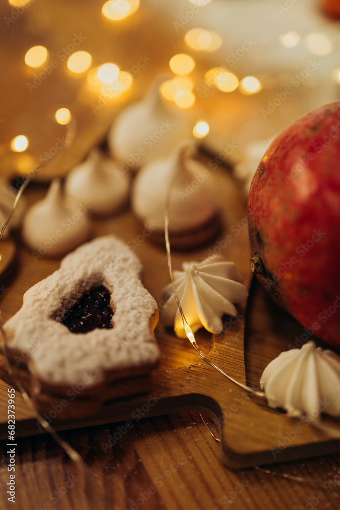 Fototapeta premium Christmas sweets and bakery close up with garlands