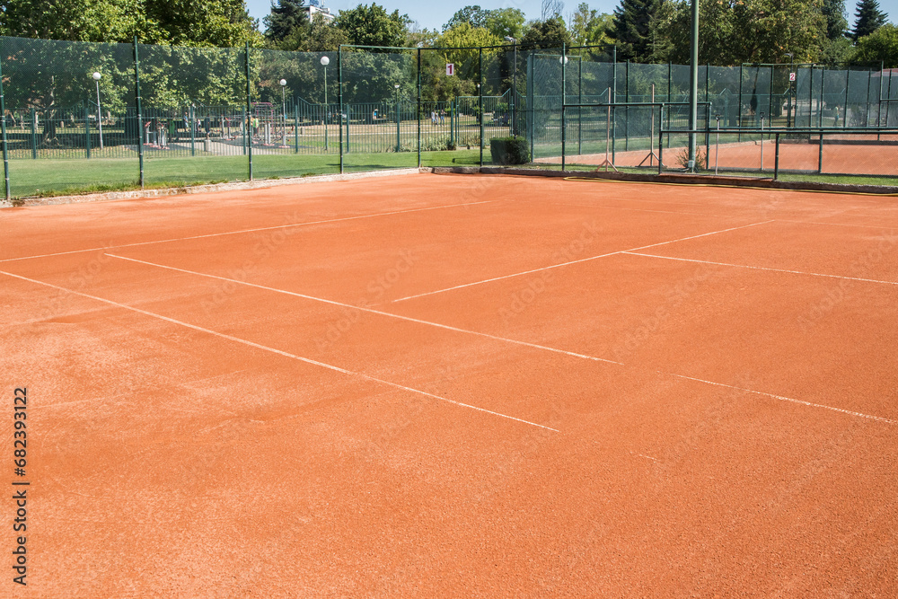 Red clay court surface closeup in tennis complex