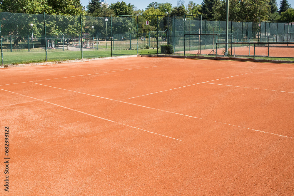 Fototapeta premium Red clay court surface closeup in tennis complex