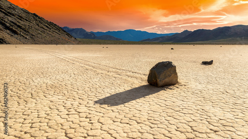 Moving stones in Racetrack Playa at sunset in Death Valley National Park, California 