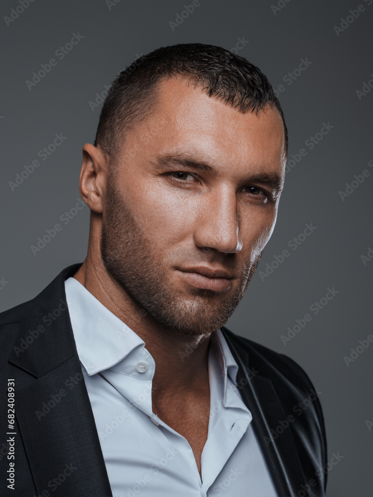 Close-up of a confident male in formal wear with a piercing look Close-up of a confident male in formal wear with a piercing look