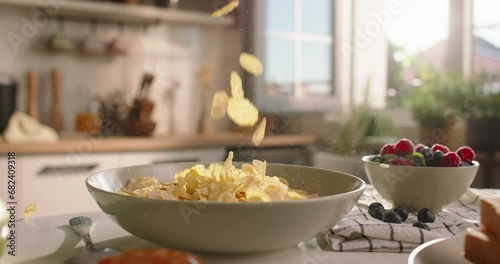 Unknown person pours cereal into plate. Advertising cinematic slow motion no people. Leisurely cozy morning, essence of lifestyle, food, and domestic life. Pleasant family traditions. Comfort concept photo