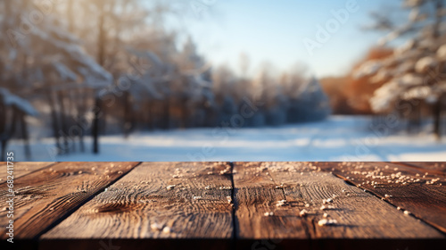 The empty wooden dark brown rustic table top with blur background of winter forest
