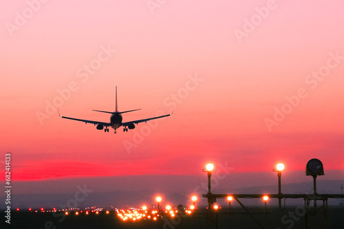 Plane lands at an airfield at the sunset © Bogdan