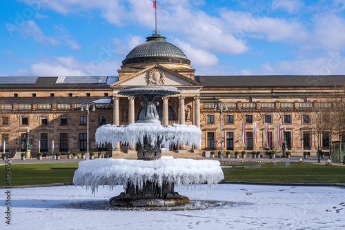 The fountain covered in ice in front of the casino in Wiesbaden/Germany photo