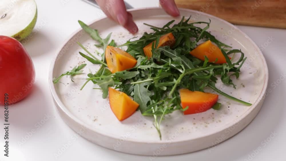 hands making salad with persimmon healthy food hands making salad with persimmon healthy food