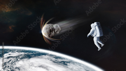 Cosmonaut with asteroid in low-Earth orbit. Elements of this image furnished by NASA.