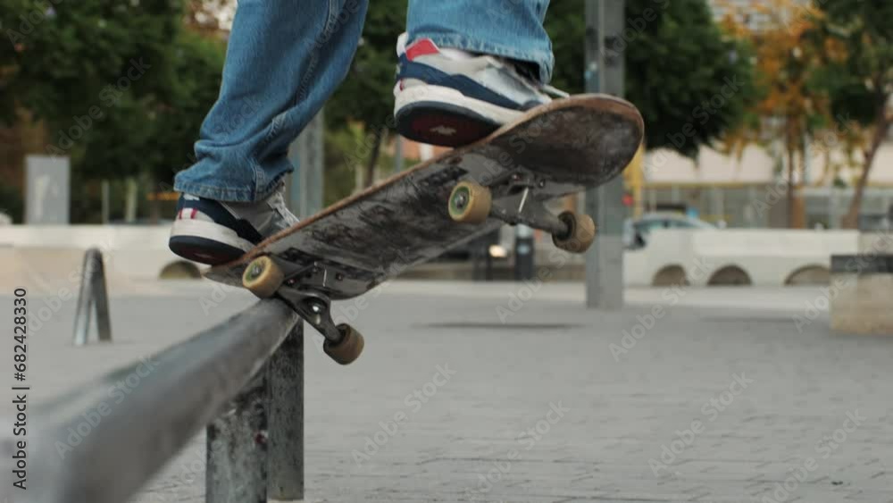 Young skater making jump and crooked grind on rail, performing trick, skateboarder training in skatepark, making slides and flips, jump over the gap, professional extreme sport athlete training ride Young skater making jump and crooked grind on rail, performing trick, skateboarder training in skatepark, making slides and flips, jump over the gap, professional extreme sport athlete training ride