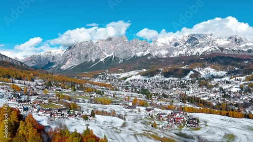 Aerial drone view of valley, snowy villages, autumn forest, Dolomites mountains Italy. High quality 4k footage