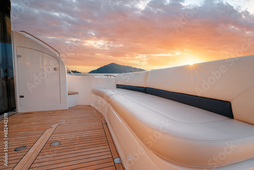 Luxury traveling. Interior of modern motor yacht on sunset photo