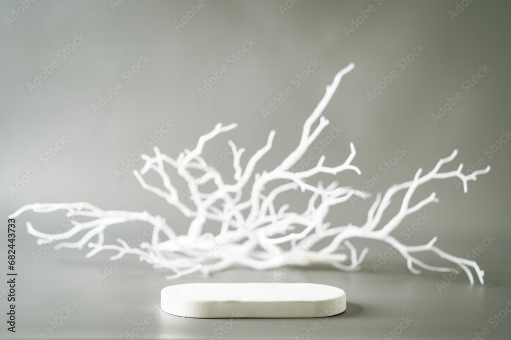 Cosmetic background for product presentation. White empty plaster podium with shadows on gray background Cosmetic background for product presentation. White empty plaster podium with shadows on gray background