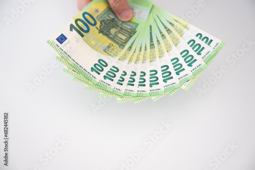 Top view on hundred euro banknotes in ans hand. Loan,salary,savings,cost of living,profit,business concept banner with plcae for text photo