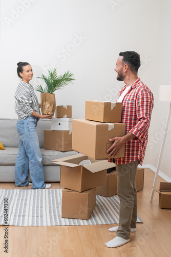 Fotografie Happy man and woman collect things in cardboard boxes to sent to another address