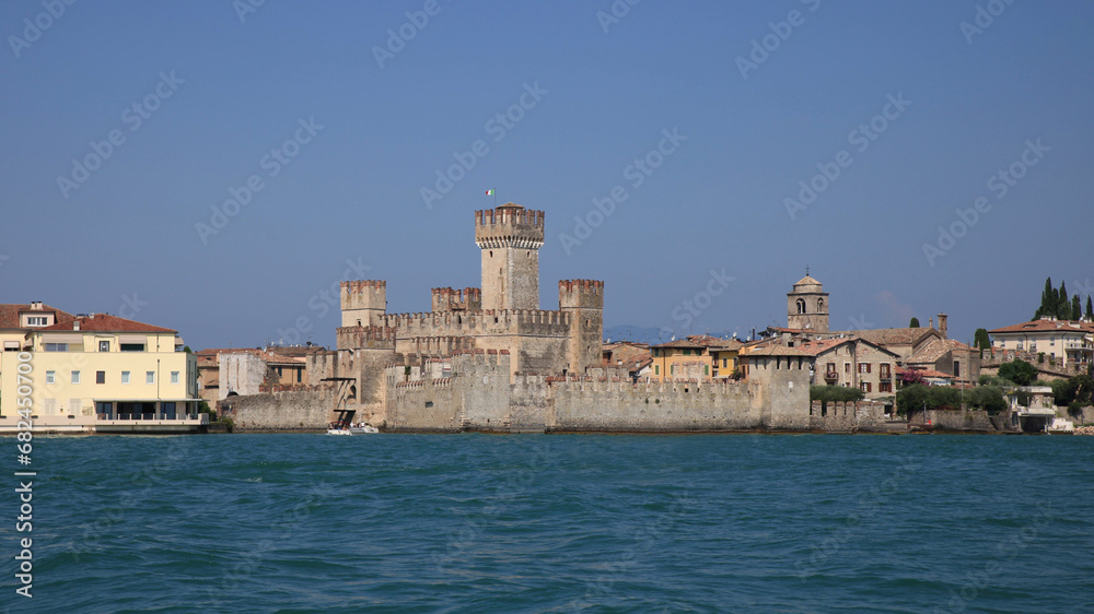 view of the castle of sirmione from lake garda with blue sky 