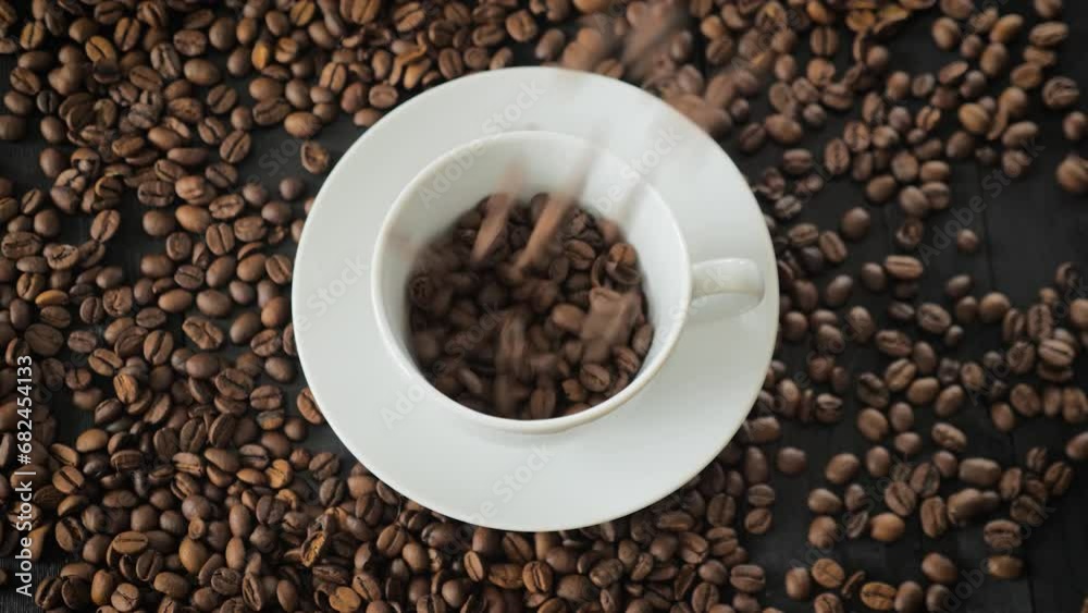 Coffee Beans falling down in a coffee cup Coffee Beans falling down in a coffee cup