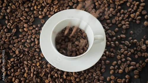Coffee Beans falling down in a coffee cup