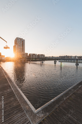 Industrial part of Ghent in the Dampoort district during sunset. Belgian industrial city. Factory industry. Chimneys and factories illuminated with orange-red light photo