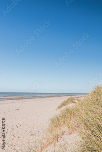 Typical beach on the Atlantic coast of Belgium during daylight hours. A place of relaxation and rest. Spending your free time