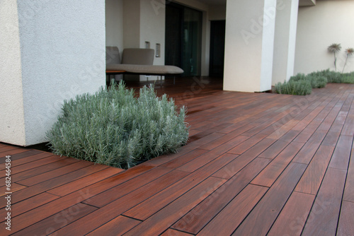 Patio with white concrete columns on hardwood deck lavender scrub pots and furniture