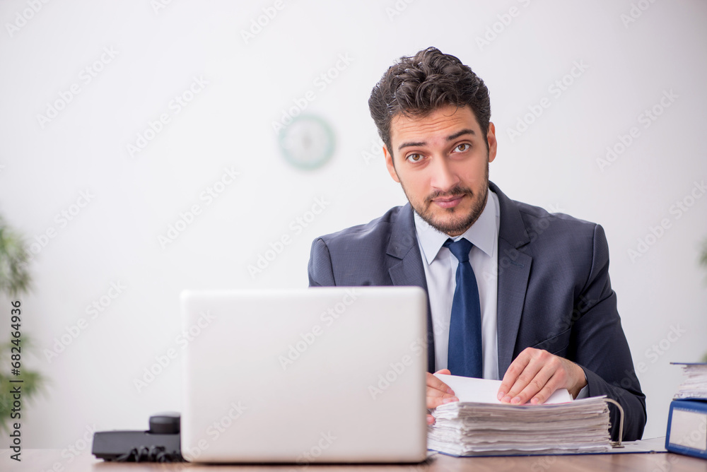 Young male employee working in the office Young male employee working in the office