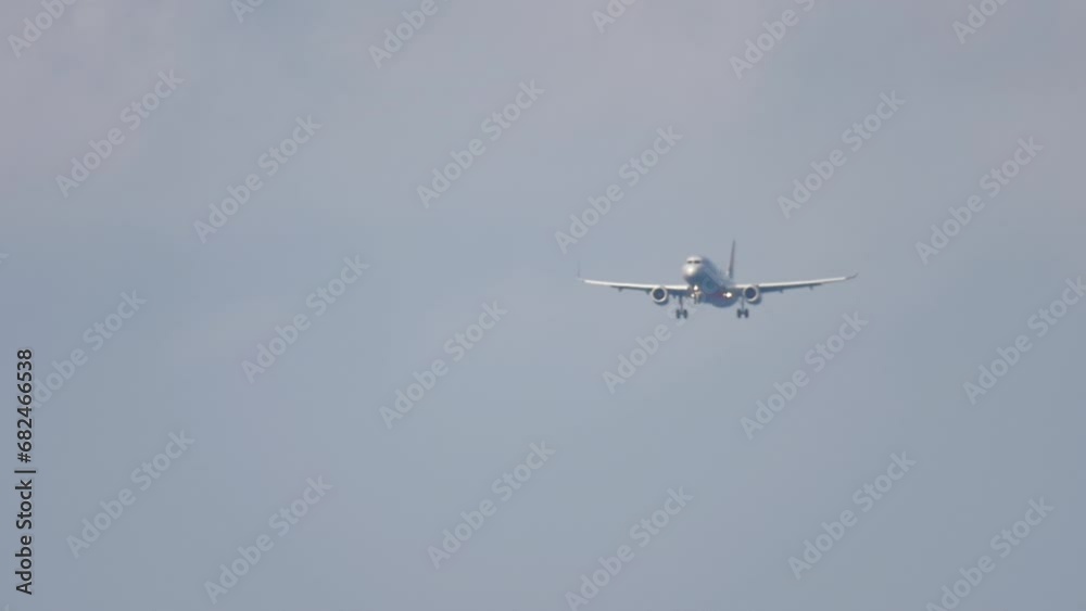 Jet aircraft with unrecognizable livery approaching landing. Passenger flies. Tourism and travel concept Jet aircraft with unrecognizable livery approaching landing. Passenger flies. Tourism and travel concept