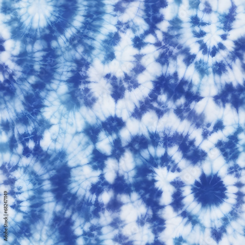 Tie dye design. Seamless repeating pattern. Dyed indigo fabric background and textured. Pattern of blue dye on cotton cloth, indigo tie dye pattern abstract background.