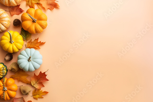 Autumn Leaves and Pumpkins on Pastel Background with Copy Space