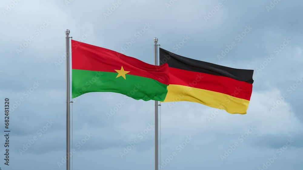Germany flag and Burkina Faso flag waving together on cloudy sky, endless seamless loop, two country relations concept Germany flag and Burkina Faso flag waving together on cloudy sky, endless seamless loop, two country relations concept