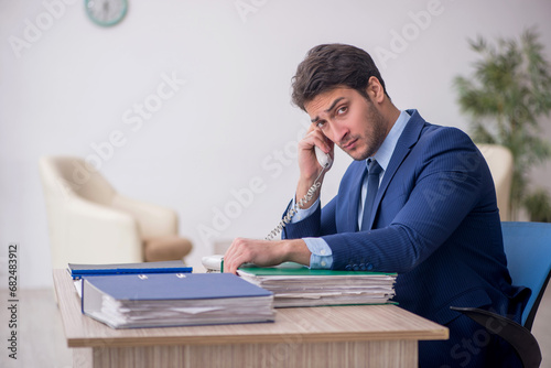 Young male employee working in the office