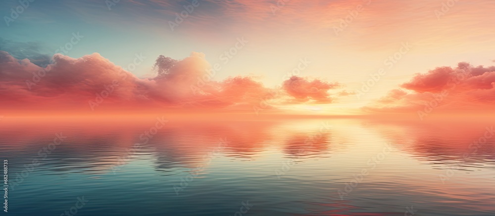 As the sun gently sinks below the horizon, the orange hues paint the sky and reflect upon the tranquil waters, creating a breathtaking landscape with beautiful clouds hovering in the evening sky. The