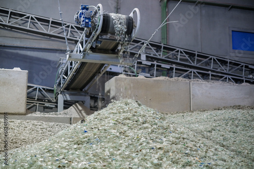 A belt transports crushed glass material ready for recycling